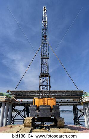 Picture - Low angle view of crane and bridge construction. Fotosearch