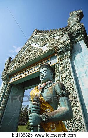 Stock Photography - Low angle view of statue and ornate archway at Angkor Wat, Siem Reap, Cambodia. Fotosearch