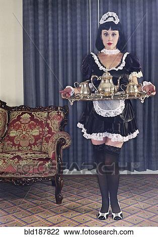 Maid serving tea in ornate living room View Large Photo Image Stock Image - Maid serving tea in ornate living room. Fotosearch