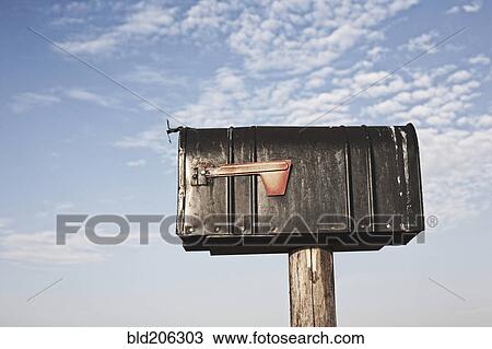 Stock Image - Mailbox On a Wooden Post. Fotosearch