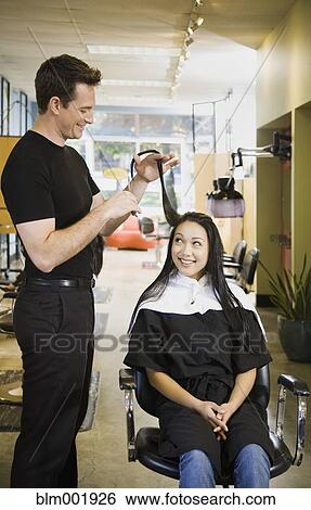 Male hair stylist cutting woman's hair View Large Photo Image Stock Photograph - Male hair stylist cutting woman's hair. Fotosearch
