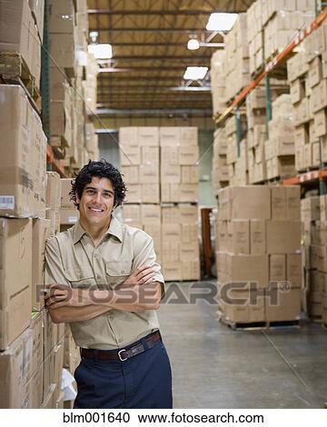 Male warehouse worker leaning on boxes View Large Photo Image Stock Image - Male warehouse worker leaning on boxes. Fotosearch