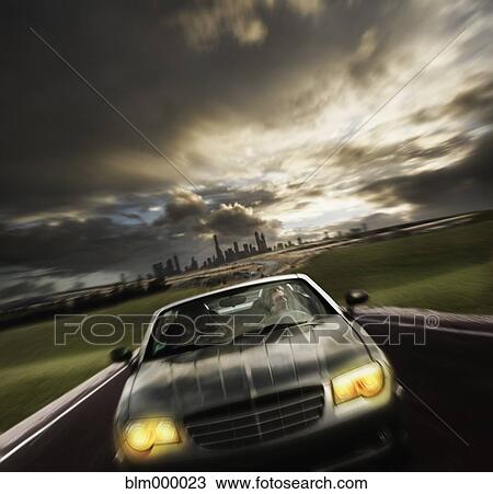 Stock Image - Man driving sports car. Fotosearch