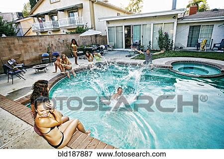 Stock Photo - Man jumping into swimming pool. Fotosearch