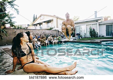 Stock Photograph - Man jumping into swimming pool. Fotosearch