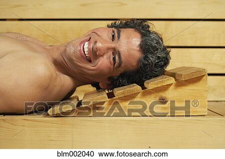 Stock Image - Man relaxing in sauna. Fotosearch