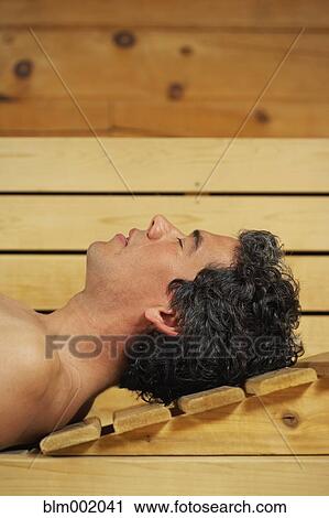 Stock Image - Man relaxing in sauna. Fotosearch