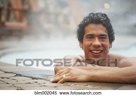 Stock Photography - Man sitting in hot tub. Fotosearch