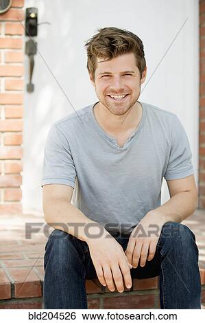 Stock Photograph - Man smiling outdoors. Fotosearch