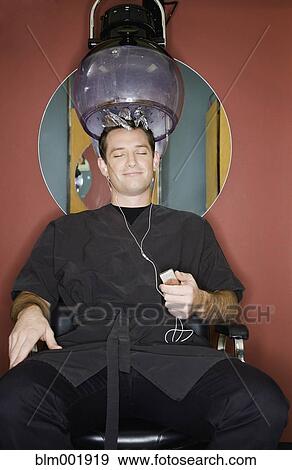 Stock Photo - Man under hair dryer in salon. Fotosearch