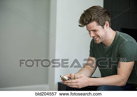 Stock Photo - Man using cell phone. Fotosearch