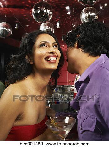 Man whispering to woman in nightclub View Large Photo Image Stock Image - Man whispering to woman in nightclub. Fotosearch