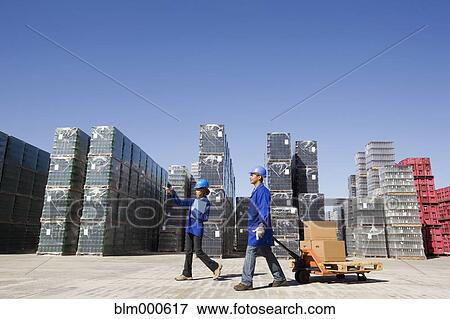 Stock Photo - Manager talking with worker at processing plant. Fotosearch