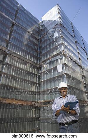 Stock Photograph - Manager talking with worker at processing plant. Fotosearch