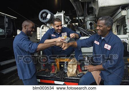 Mechanics eating lunch together View Large Photo Image Picture - Mechanics eating lunch together. Fotosearch