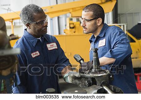 Mechanics working together View Large Photo Image Stock Photography - Mechanics working together. Fotosearch