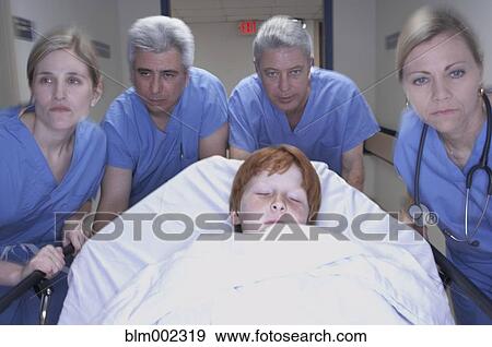 Medical professionals pushing patient on gurney View Large Photo Image Stock Photo - Medical professionals pushing patient on gurney. Fotosearch
