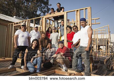 Picture - Men and women at construction site. Fotosearch