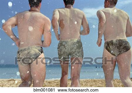 Stock Image - Men covered in sand running toward beach. Fotosearch