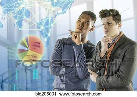 Stock Image - Men examining illuminated holograms. Fotosearch