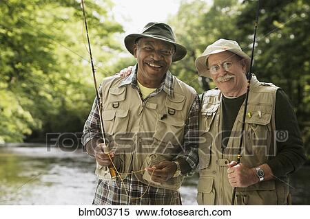 Stock Photography - Men in fishing vests holding fishing rods. Fotosearch