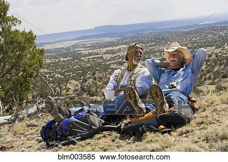 Stock Photography - Men relaxing in remote area. Fotosearch