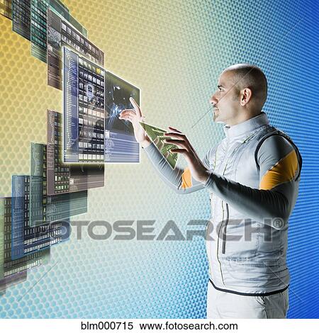 Stock Photography - Middle eastern businessman working at futuristic control panels. Fotosearch