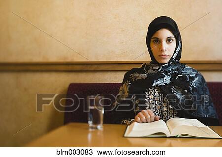 Middle Eastern teenager in headscarf reading book View Large Photo Image Stock Image - Middle Eastern teenager in headscarf reading book. Fotosearch