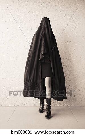Stock Photography - Middle Eastern woman in burka and high heeled boots. Fotosearch