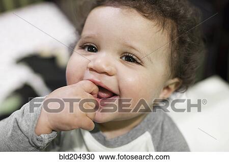 Stock Image - Mixed race baby smiling. Fotosearch