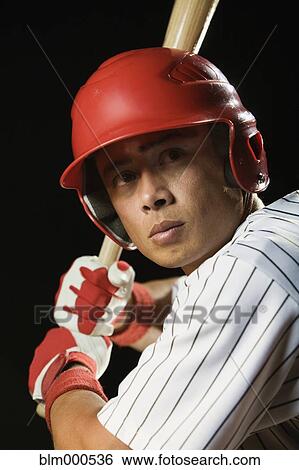 Stock Photograph - Mixed race baseball player batting. Fotosearch