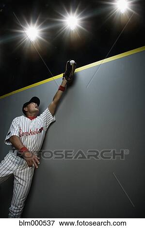 Mixed race baseball player catching ball View Large Photo Image Stock Photo - Mixed race baseball player catching ball. Fotosearch