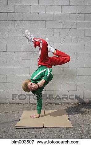 Stock Photo - Mixed race boy breakdancing. Fotosearch