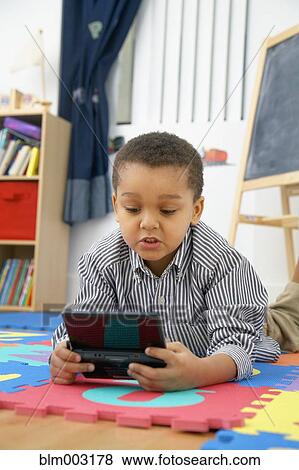 Mixed race boy playing video game View Large Photo Image Stock Photo - Mixed race boy playing video game. Fotosearch