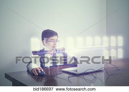 Stock Photo - Mixed race boy using computer with holographic files. Fotosearch