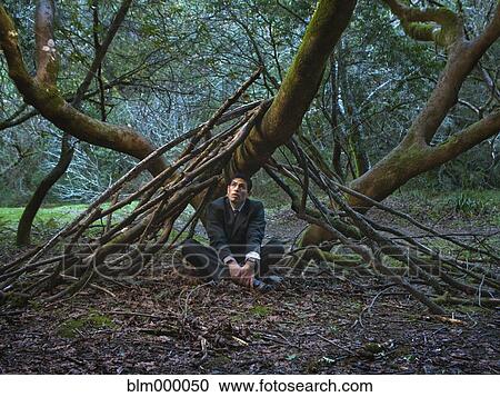 Mixed Race businessman sitting under tree View Large Photo Image Stock Image - Mixed Race businessman sitting under tree. Fotosearch
