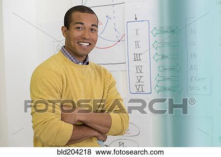 Stock Photo - Mixed race businessman smiling in office. Fotosearch