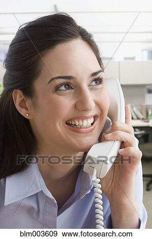 Stock Photo - Mixed race businesswoman on telephone. Fotosearch