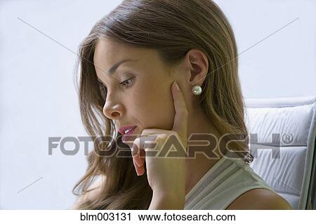 Stock Image - Mixed race businesswoman working at desk. Fotosearch