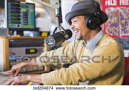 Mixed race disc jockey using turntable in studio View Large Photo Image Picture - Mixed race disc jockey using turntable in studio. Fotosearch