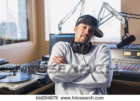 Mixed race disc jockey with arms crossed in studio View Large Photo Image Stock Photo - Mixed race disc jockey with arms crossed in studio. Fotosearch