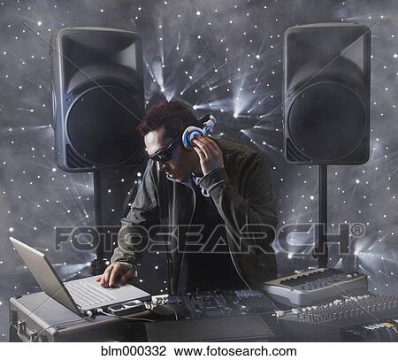 Mixed race DJ working with equipment View Large Photo Image Stock Image - Mixed race DJ working with equipment. Fotosearch