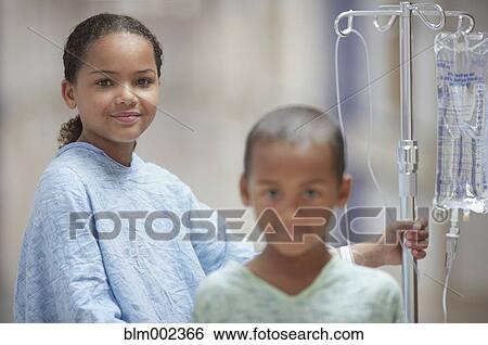 Mixed Race girl and boy in hospital gowns View Large Photo Image Stock Photograph - Mixed Race girl and boy in hospital gowns. Fotosearch