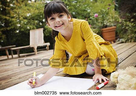 Mixed race girl coloring on deck View Large Photo Image Stock Photography - Mixed race girl coloring on deck. Fotosearch
