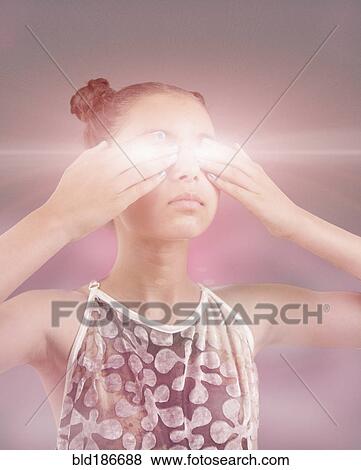 Stock Photo - Mixed race girl covering glowing eyes. Fotosearch