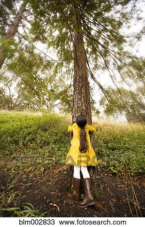 Mixed race girl hugging tree View Large Photo Image Stock Image - Mixed race girl hugging tree. Fotosearch