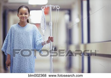 Stock Photo - Mixed Race girl in hospital gown. Fotosearch