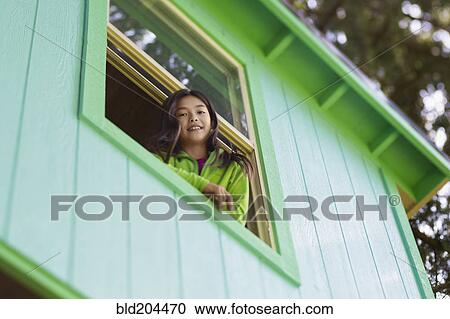 Mixed race girl leaning out window View Large Photo Image Stock Image - Mixed race girl leaning out window. Fotosearch