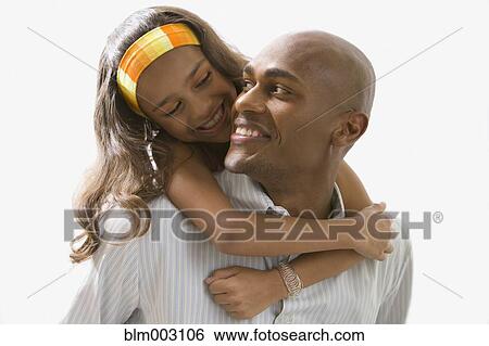Stock Photograph - Mixed race girl smiling and hugging father. Fotosearch