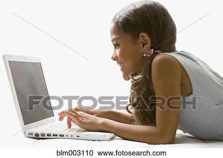 Mixed race girl using laptop View Large Photo Image Stock Image - Mixed race girl using laptop. Fotosearch